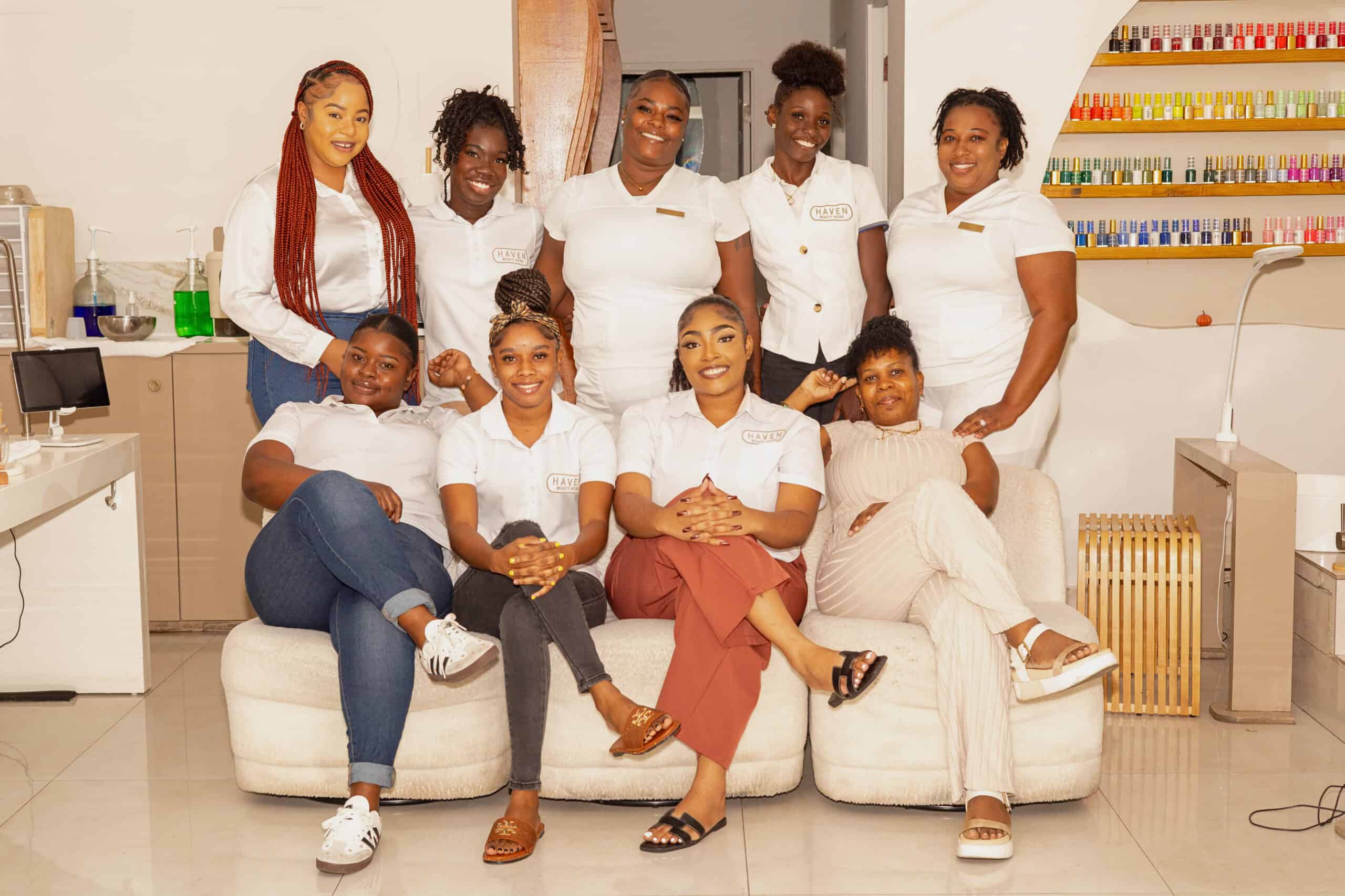 A diverse group of professional beauty therapists smiling and posing together at Haven Beauty House, showcasing expertise in skincare, beauty services, and customer care in a welcoming spa environment.