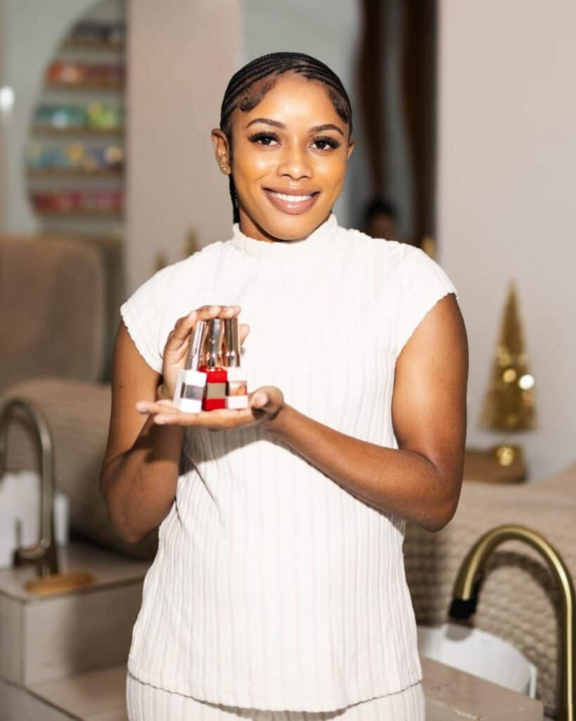 Elegant woman holding nail polish bottles at Haven Beauty House, a professional beauty and wellness spa offering manicure, pedicure, and skincare treatments in a soothing environment.